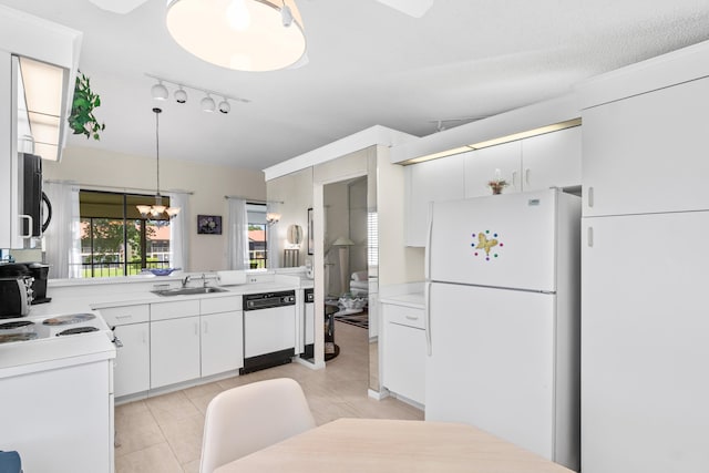 10263 N Circle Lake Dr Unit 201, Boynton Beach, FL 33437 - kitchen featuring white appliances, rail lighting, light countertops, a chandelier, and decorative light fixtures
