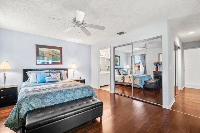 10263 N Circle Lake Dr Unit 201, Boynton Beach, FL 33437 - bedroom with wood finished floors, a textured ceiling, ceiling fan, and ensuite bathroom