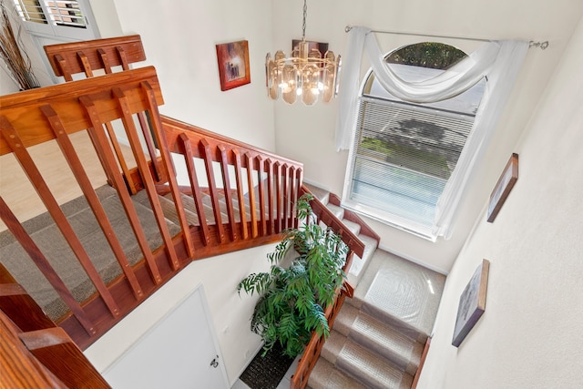 10263 N Circle Lake Dr Unit 201, Boynton Beach, FL 33437 - staircase featuring a chandelier
