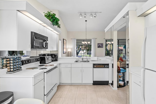 10263 N Circle Lake Dr Unit 201, Boynton Beach, FL 33437 - kitchen with white appliances, a chandelier, light countertops, white cabinetry, and pendant lighting