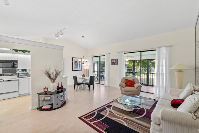10263 N Circle Lake Dr Unit 201, Boynton Beach, FL 33437 - living area featuring lofted ceiling, a chandelier, and track lighting