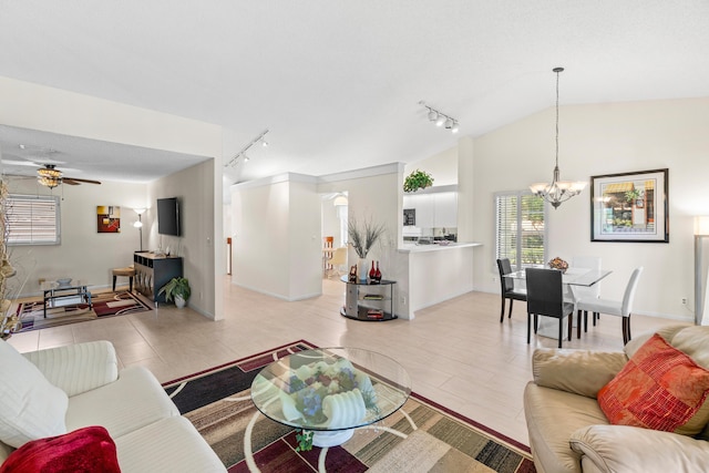 10263 N Circle Lake Dr Unit 201, Boynton Beach, FL 33437 - living room with rail lighting, a chandelier, a ceiling fan, and vaulted ceiling