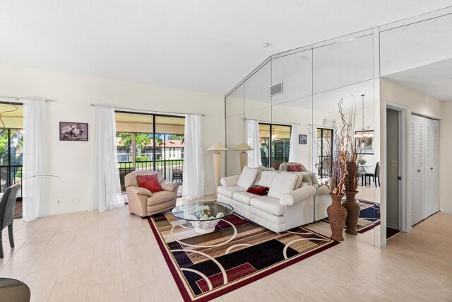 10263 N Circle Lake Dr Unit 201, Boynton Beach, FL 33437 - living room with baseboards and lofted ceiling