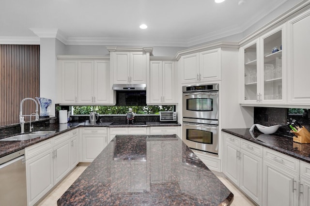 718 Edgebrook Ln, West Palm Beach, FL 33411 - kitchen featuring stainless steel appliances, crown molding, white cabinetry, glass insert cabinets, and tasteful backsplash