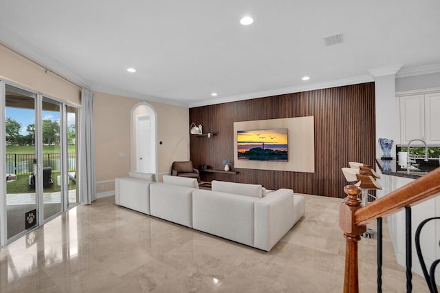 718 Edgebrook Ln, West Palm Beach, FL 33411 - living area with ornamental molding, arched walkways, recessed lighting, an accent wall, and wood walls
