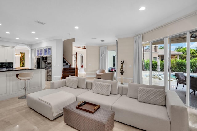 718 Edgebrook Ln, West Palm Beach, FL 33411 - living area featuring arched walkways, recessed lighting, stairs, and ornamental molding