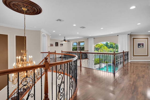 718 Edgebrook Ln, West Palm Beach, FL 33411 - corridor with an upstairs landing, a chandelier, wood finished floors, crown molding, and recessed lighting
