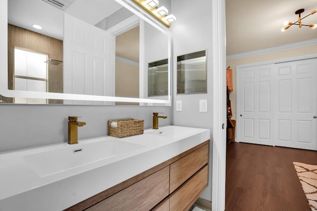 718 Edgebrook Ln, West Palm Beach, FL 33411 - full bath with crown molding, double vanity, wood finished floors, and a chandelier