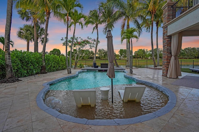 718 Edgebrook Ln, West Palm Beach, FL 33411 - pool at dusk with a patio area