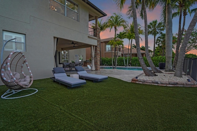 718 Edgebrook Ln, West Palm Beach, FL 33411 - yard at dusk with a deck, a ceiling fan, and a balcony