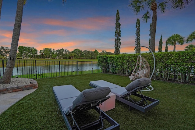 718 Edgebrook Ln, West Palm Beach, FL 33411 - yard at dusk featuring a fenced backyard and a water view