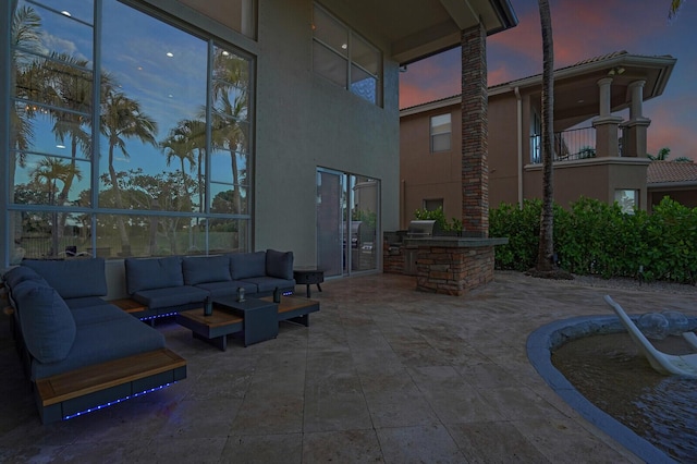 718 Edgebrook Ln, West Palm Beach, FL 33411 - patio terrace at dusk with an outdoor hangout area, area for grilling, and a patio area