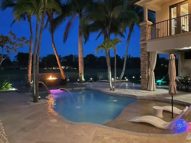 718 Edgebrook Ln, West Palm Beach, FL 33411 - pool at night with a patio and a fenced backyard