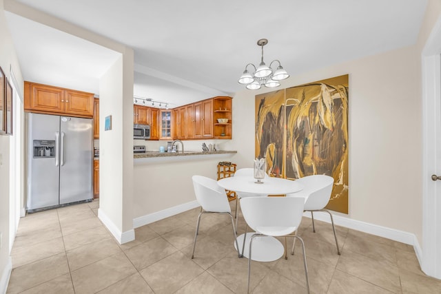 182 Charter Way, West Palm Beach, FL 33407 - dining room featuring a chandelier and light tile patterned floors