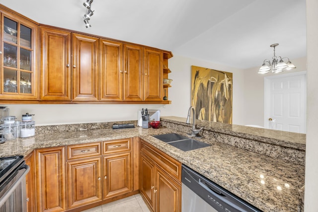 182 Charter Way, West Palm Beach, FL 33407 - kitchen with stainless steel appliances, brown cabinetry, light stone countertops, and a chandelier