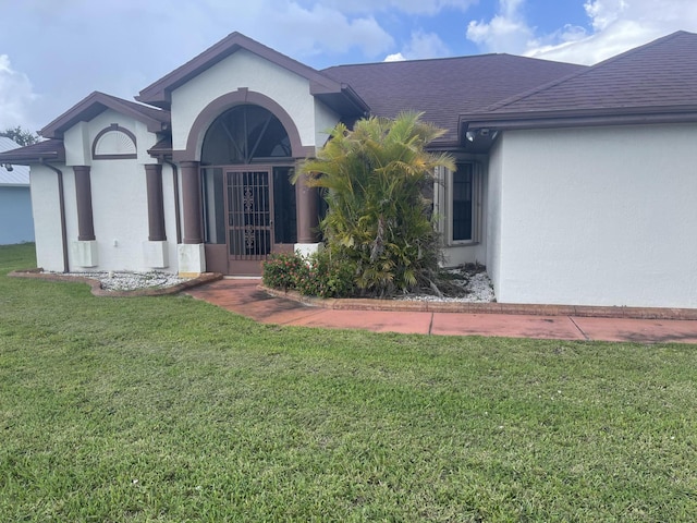 3128 SE Card Ter N, Port Saint Lucie, FL 34984 - view of front of home with stucco siding and a front yard