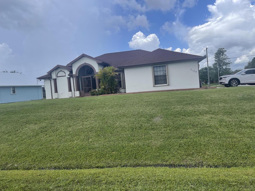 3128 SE Card Ter N, Port Saint Lucie, FL 34984 - single story home featuring stucco siding and a front lawn