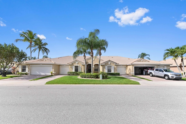 8404 Long Bay, West Palm Beach, FL 33411 - view of front facade featuring stucco siding, driveway, a front yard, and a garage