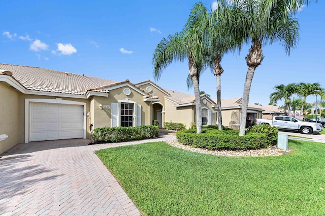 8404 Long Bay, West Palm Beach, FL 33411 - view of front of house featuring decorative driveway, stucco siding, an attached garage, and a front yard
