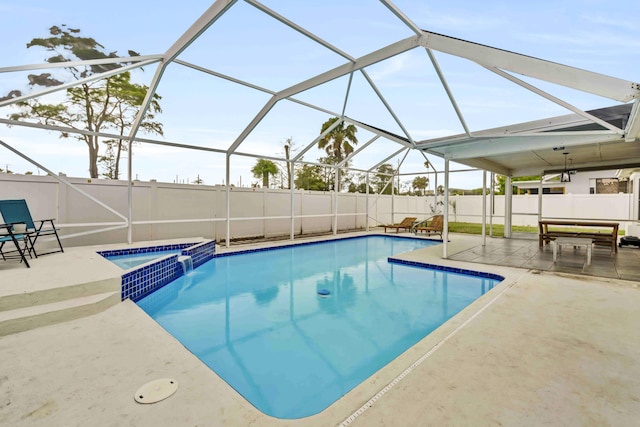 108 Timber Run E, Riviera Beach, FL 33407 - view of swimming pool featuring a patio area, a fenced backyard, a pool with connected hot tub, and glass enclosure