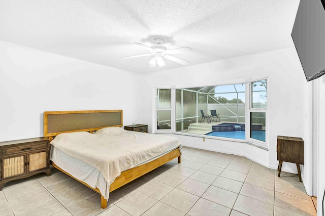 108 Timber Run E, Riviera Beach, FL 33407 - bedroom featuring light tile patterned floors, a textured ceiling, and a ceiling fan