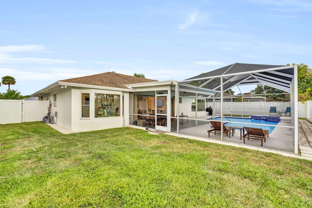 108 Timber Run E, Riviera Beach, FL 33407 - rear view of property featuring a fenced backyard, stucco siding, a patio, and a lanai