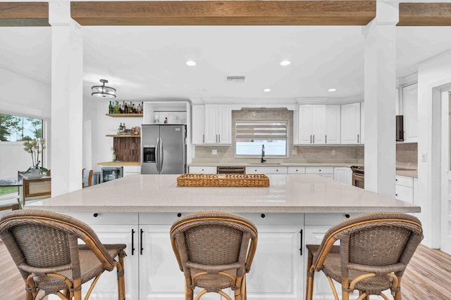 108 Timber Run E, Riviera Beach, FL 33407 - kitchen with appliances with stainless steel finishes, light wood finished floors, white cabinets, recessed lighting, and backsplash