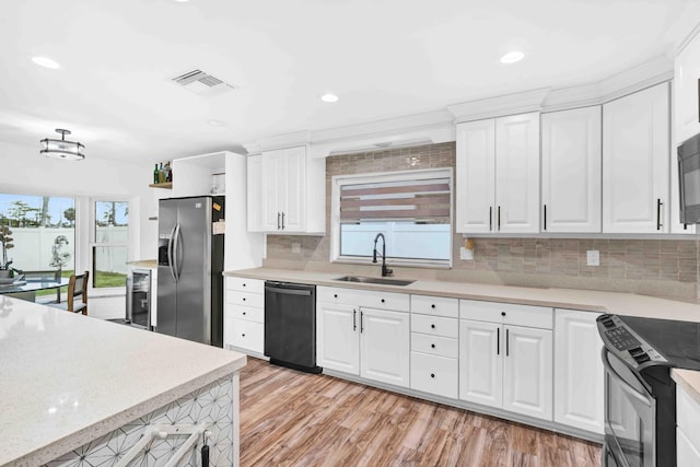 108 Timber Run E, Riviera Beach, FL 33407 - kitchen with black appliances, light wood-style floors, white cabinets, tasteful backsplash, and wine cooler