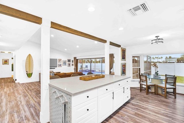 108 Timber Run E, Riviera Beach, FL 33407 - kitchen with light wood-style flooring, light countertops, white cabinets, recessed lighting, and open floor plan