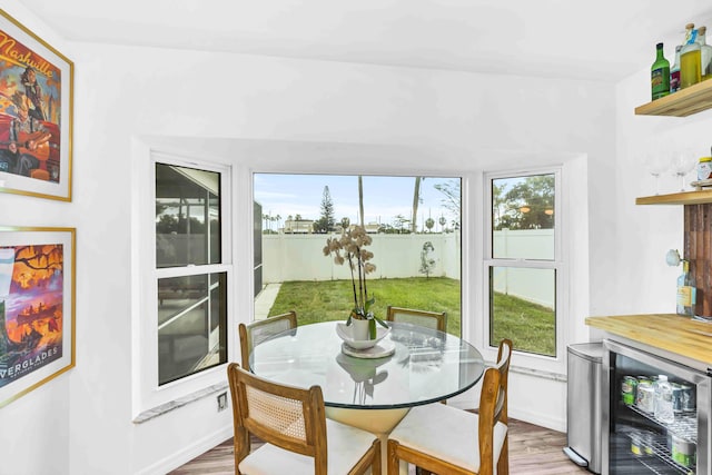 108 Timber Run E, Riviera Beach, FL 33407 - dining space featuring wood finished floors, a bar, and wine cooler