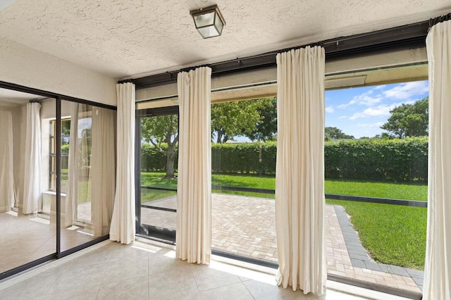 416 Cottonwood Pl, Boca Raton, FL 33431 - doorway featuring tile patterned flooring and a textured ceiling