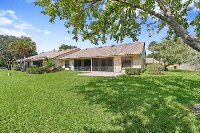 416 Cottonwood Pl, Boca Raton, FL 33431 - back of house featuring stucco siding, a tiled roof, a yard, a sunroom, and a patio