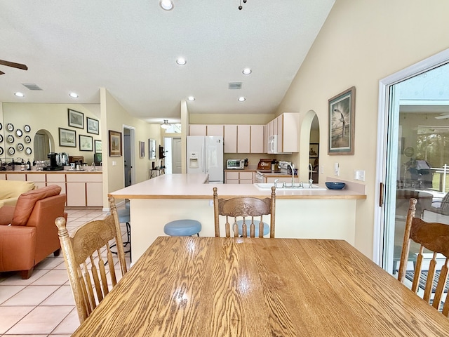 13021 150th Ct N, Jupiter, FL 33478 - dining room with arched walkways, light tile patterned floors, ceiling fan, recessed lighting, and a textured ceiling