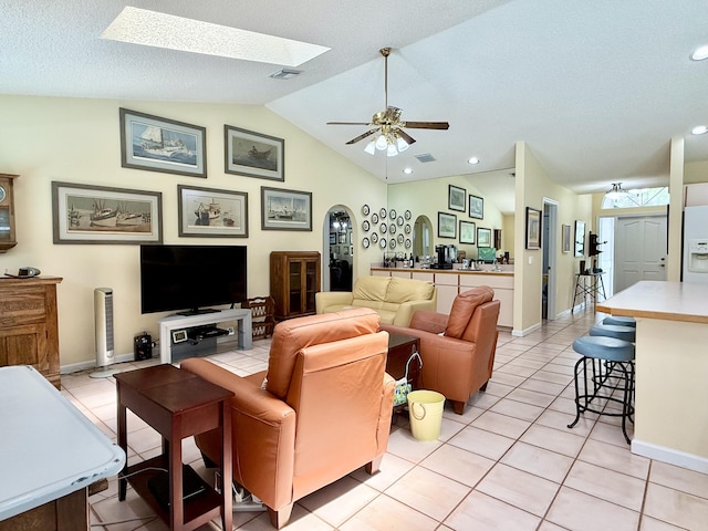 13021 150th Ct N, Jupiter, FL 33478 - living area with lofted ceiling, a skylight, light tile patterned floors, a ceiling fan, and recessed lighting