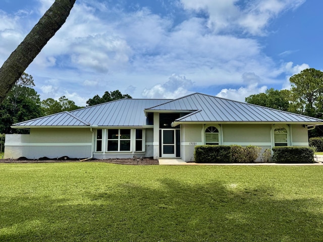 13021 150th Ct N, Jupiter, FL 33478 - view of front of house featuring a standing seam roof, stucco siding, and a metal roof