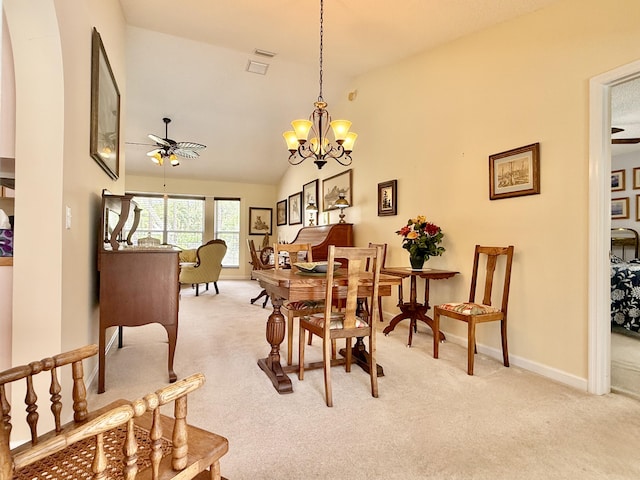 13021 150th Ct N, Jupiter, FL 33478 - dining area featuring light colored carpet, a ceiling fan, a chandelier, and vaulted ceiling