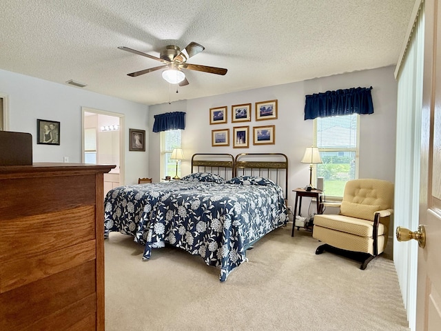 13021 150th Ct N, Jupiter, FL 33478 - carpeted bedroom with a textured ceiling, a ceiling fan, and ensuite bathroom