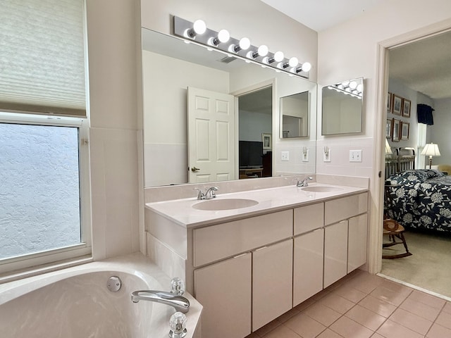 13021 150th Ct N, Jupiter, FL 33478 - full bathroom with connected bathroom, tile patterned flooring, double vanity, and a tub to relax in