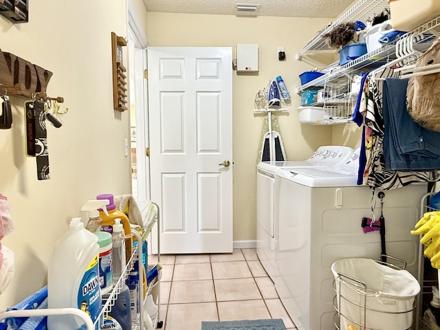 13021 150th Ct N, Jupiter, FL 33478 - washroom with washer and dryer, light tile patterned flooring, and a textured ceiling
