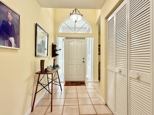 13021 150th Ct N, Jupiter, FL 33478 - entryway featuring light tile patterned flooring and a textured ceiling