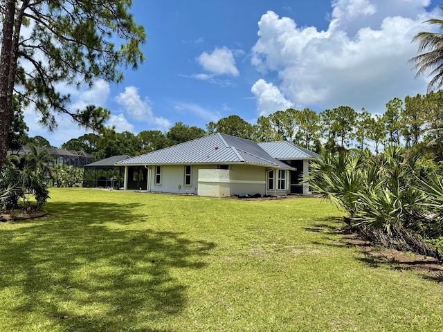 13021 150th Ct N, Jupiter, FL 33478 - rear view of house featuring a lawn, a metal roof, and a standing seam roof