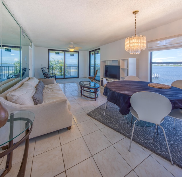 896 N Federal Hwy Unit 324, Lantana, FL 33462 - living area featuring a textured ceiling, a chandelier, a ceiling fan, and light tile patterned flooring