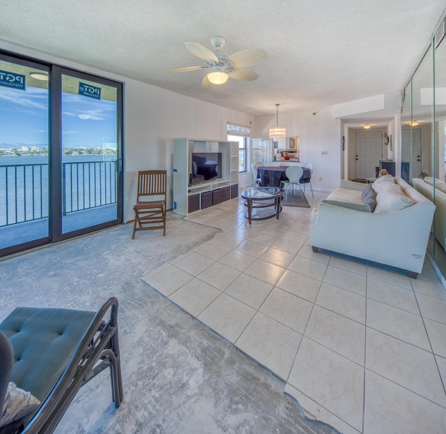 896 N Federal Hwy Unit 324, Lantana, FL 33462 - living room with a textured ceiling, a chandelier, light tile patterned floors, and ceiling fan