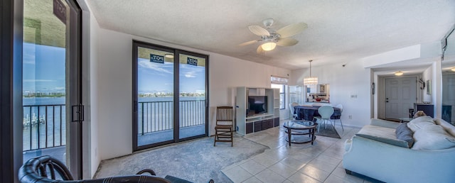 896 N Federal Hwy Unit 324, Lantana, FL 33462 - living room featuring a textured ceiling, ceiling fan, tile patterned flooring, and a chandelier