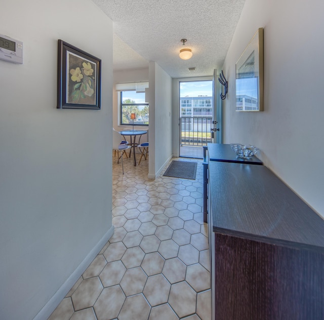 896 N Federal Hwy Unit 324, Lantana, FL 33462 - hall featuring baseboards and a textured ceiling