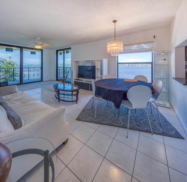 896 N Federal Hwy Unit 324, Lantana, FL 33462 - tiled living room with a textured ceiling, a chandelier, and ceiling fan