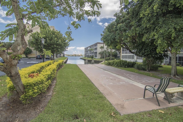 896 N Federal Hwy Unit 324, Lantana, FL 33462 - view of community featuring a yard, shuffleboard, a water view, and concrete driveway