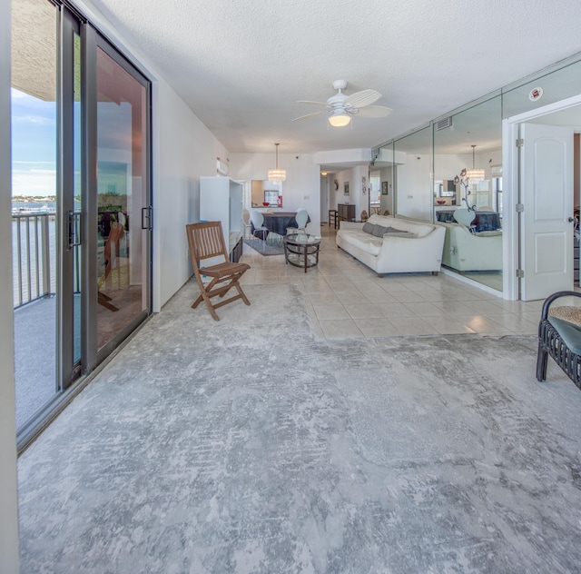 896 N Federal Hwy Unit 324, Lantana, FL 33462 - living area with a textured ceiling, a ceiling fan, and tile patterned flooring