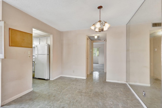 47 Camden Unit B, West Palm Beach, FL 33417 - empty room featuring baseboards and a chandelier
