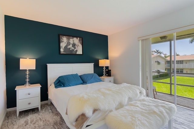 740 Horizons W Unit 207, Boynton Beach, FL 33435 - bedroom featuring access to exterior, multiple windows, light carpet, and an accent wall